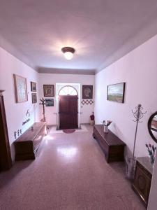 a large room with a door and a hallway with tables at CupraScìScì in Cupra Marittima