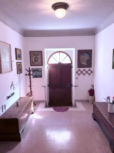 a room with a wooden door in a room with a table at CupraScìScì in Cupra Marittima