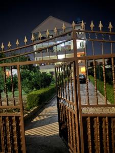 a wooden gate in front of a house at Airport Double Room in Kamëz