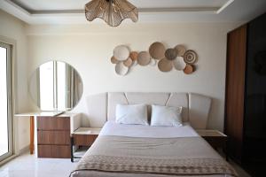 a bedroom with a bed and a mirror on the wall at Sharm Hills Luxury Pool View in Sharm El Sheikh +127 photos