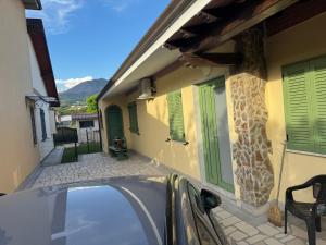 a car parked in front of a house with a window at Casa Narciso, semi-detached cottage in Marina di Massa