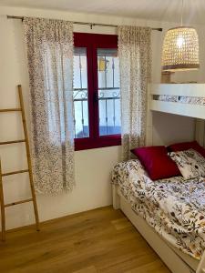 a bedroom with a bunk bed and a window at Appart 70m2 avec piscine in Saint-Geniès-de-Varensal +41 photos