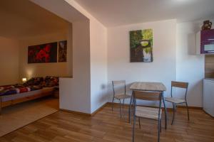 a living room with a table and chairs and a bed at U Moto Makovic in Horažďovice