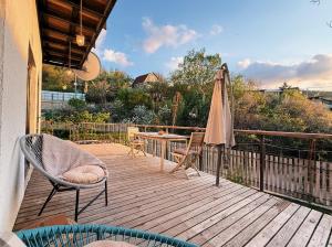 a patio with an umbrella and chairs and a table at Alexa Mountain Homes in Kok-Shoky