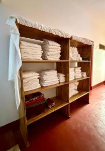 a book shelf filled with lots of towels at Karibu Burudika Lodge in Bagamoyo