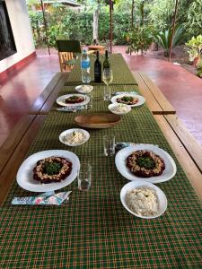 a table with plates of food on top of it at Karibu Burudika Lodge in Bagamoyo
