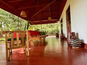 a living room with wooden furniture in a house at Karibu Burudika Lodge in Bagamoyo +12 photos