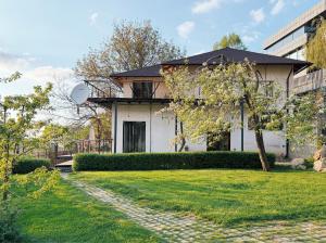 a white house with a walkway in front of a yard at Alexa Mountain Homes in Kok-Shoky