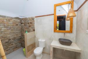 a bathroom with a toilet and a sink and a mirror at Heyho Bungalow in Maluk +29 photos