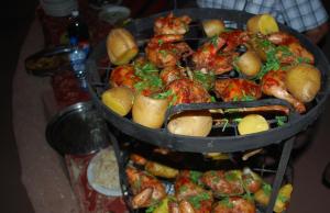 two trays of food with shrimp and potatoes on a table at Jordan Tracks Bedouin Camp in Wadi Rum