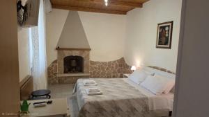 a bedroom with a bed with a stone fireplace at Il Trulletto in Impalata