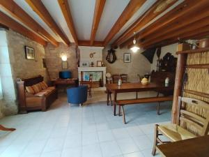a living room with a table and a couch at Le Logis de bouillé in Bouillé-Courdault