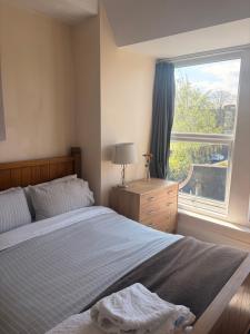 a bedroom with a large bed and a window at The Avenue GuestHouse in Newcastle upon Tyne