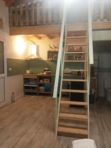 a loft bed with a ladder in a room at Casa do Peregrino in Advagar +7 photos
