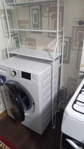 a washer and dryer sitting in a room at UYUT INN apartment in Samarkand