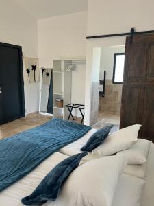 a bedroom with a large bed with pillows at Les maisons de loup a loup in Cotignac +24 photos
