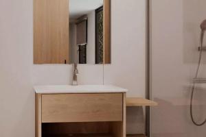 a bathroom with a sink and a mirror at Sènia Botànic Bonavista in Calella +41 photos