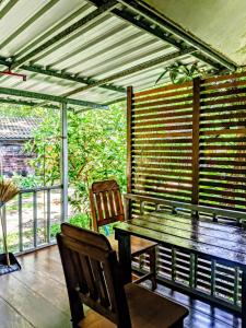 a wooden table and two chairs in a room at Lake view house in Ko Phangan