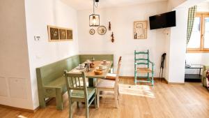 a dining room with a table and chairs at Verde Betulla, Free Park and Ski room in Camporosso in Valcanale
