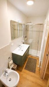a bathroom with a sink and a shower at Verde Betulla, Free Park and Ski room in Camporosso in Valcanale