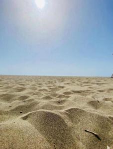 a sandy beach with footprints in the sand at Camping Ohel in Mullini i Danit +3 photos