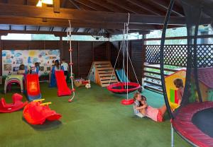 a group of children playing in an indoor playground at Camping Castello in Neos Marmaras