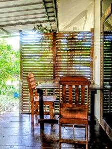 two wooden chairs and a table and a table and chairs at Lake view house in Ko Phangan +92 photos