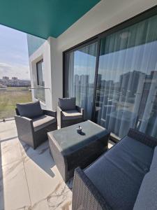 a balcony with a table and chairs on a building at Blue life Long beach in Iskele