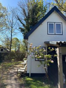 a white house with a door and a tree at Blossom in Bergen