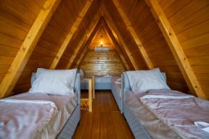 a room with two beds in a attic at Rural Resort Tron Gold in Plužine