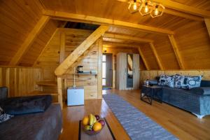 a living room of a log cabin with wooden ceilings at Rural Resort Tron Gold in Plužine