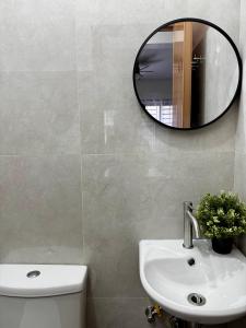 a bathroom with a sink and a mirror on the wall at Sebastians CRIB D in Dasmariñas