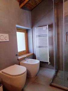 a bathroom with a toilet and a sink and a shower at B&B Court1828 in Lillianes