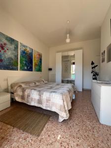 a bedroom with a bed and paintings on the walls at Alloggio Primavera in Terni