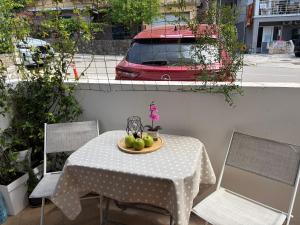 a table with a plate of apples on a balcony at Apartman Biljana in Rafailovici