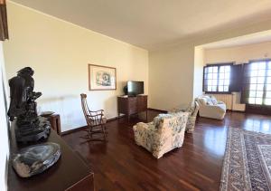 a living room with a couch and a table and chairs at Villa Krizia - Ancona, meravigliosa villa con piscina vista mare in Ancona