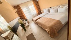 a hotel room with a large bed and a window at Hotel Sport B90 in Buzău