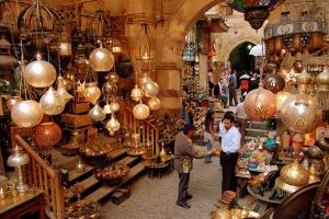 a couple of people standing in a market with lamps at locanda pyramids view & Jacuzii in Cairo