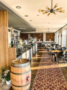 a restaurant with a bar with tables and chairs at Moselhotel Römischer Kaiser `Staffuntil5pm`EarlyBirdBreakfast`CityParking in Bernkastel-Kues