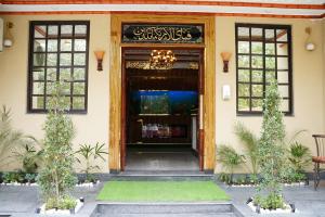 a front door of a building with a chandelier at Hotel Grand Orchard in Lahore