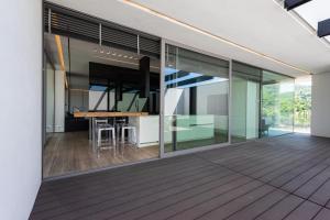 an open kitchen and dining area of a house with glass at Villa Bilor Luxe by MMega in Subbiano