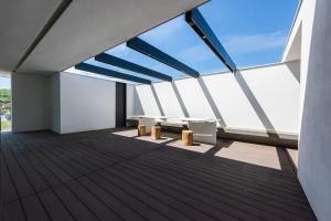 a balcony of a building with benches and windows at Villa Bilor Luxe by MMega in Subbiano