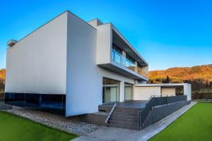 a large white house with stairs and grass at Villa Bilor Luxe by MMega in Subbiano