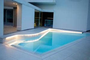 a swimming pool in the middle of a building at Villa Bilor Luxe by MMega in Subbiano