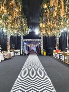 a large hall with a black and white dance floor at Avinash International in Jagdalpur +58 photos