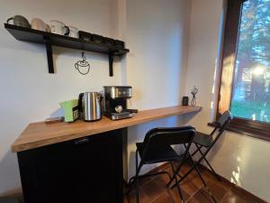 a kitchen with a counter with a coffee maker on it at Still Garden House in Bezden