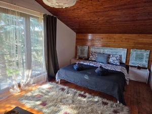 a bedroom with two cats laying on a bed at Still Garden House in Bezden