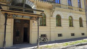 a bike parked in front of a building at Mini-hotel Franko Park in Lviv