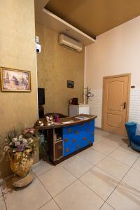 a kitchen with a blue island in a room at Mini-hotel Franko Park in Lviv