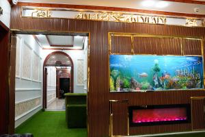 an aquarium in the hallway of a building with an aquarium at Hotel Grand Orchard in Lahore